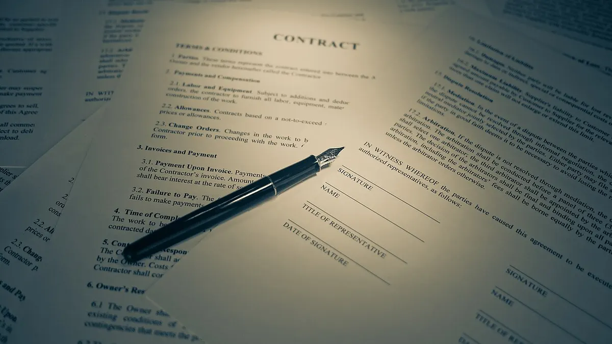 A contract with a pen ready for signature