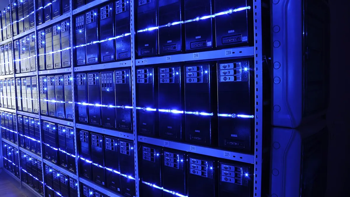 Rows of servers lit by blue lights in a data centre